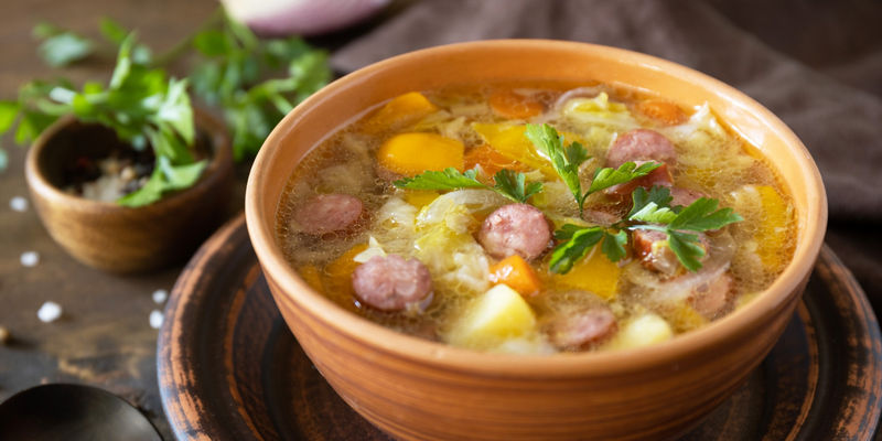 Rustic sausage and vegetable soup in bowl
