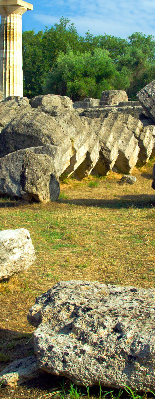 Ancient ruins with column under blue sky
