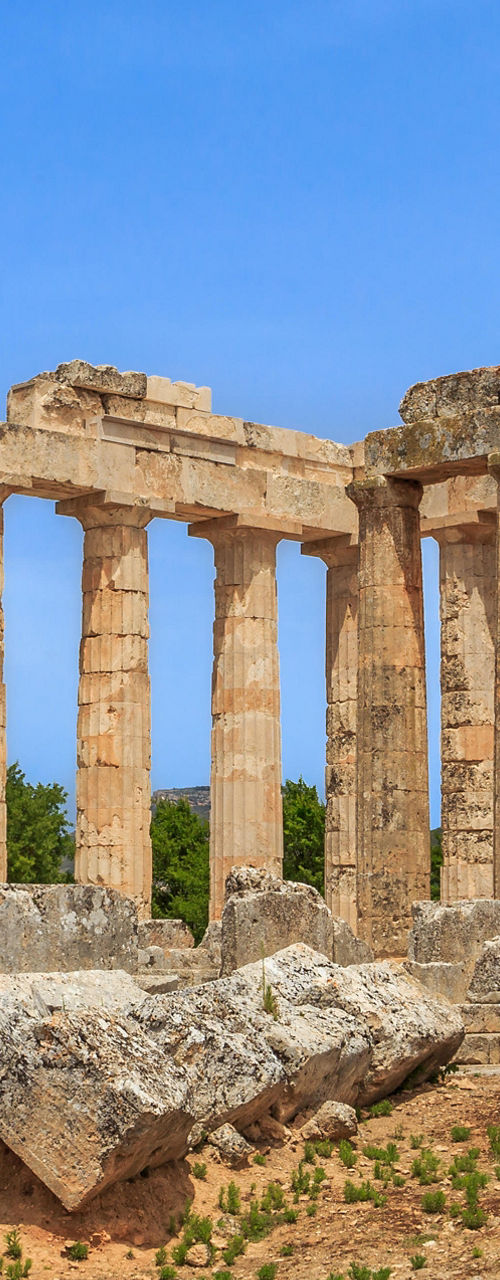 Ancient Greek temple ruins under blue sky