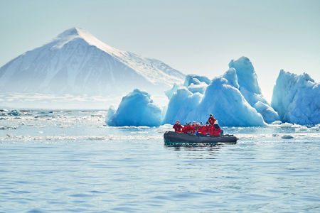Group exploring icy waters near glacier