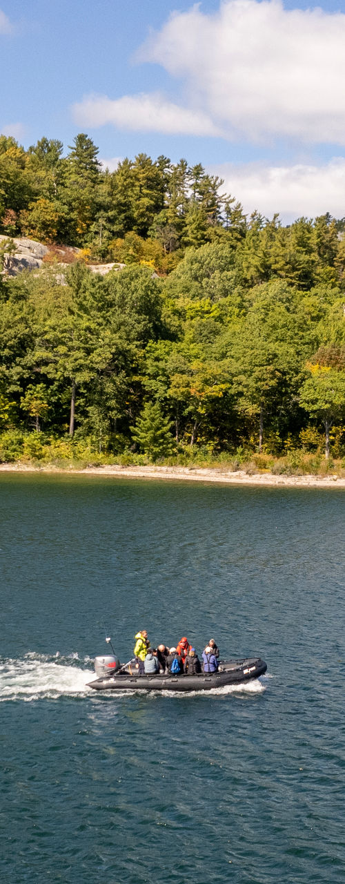 Group boating on scenic lake under blue sky