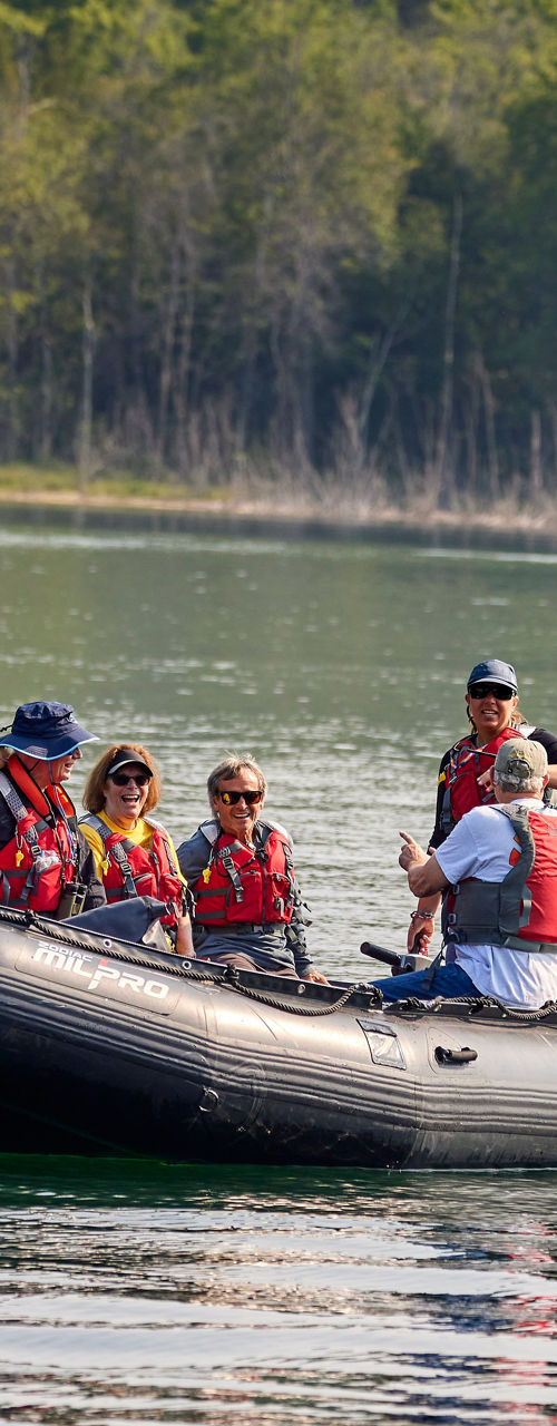 Group on inflatable boat in scenic lake