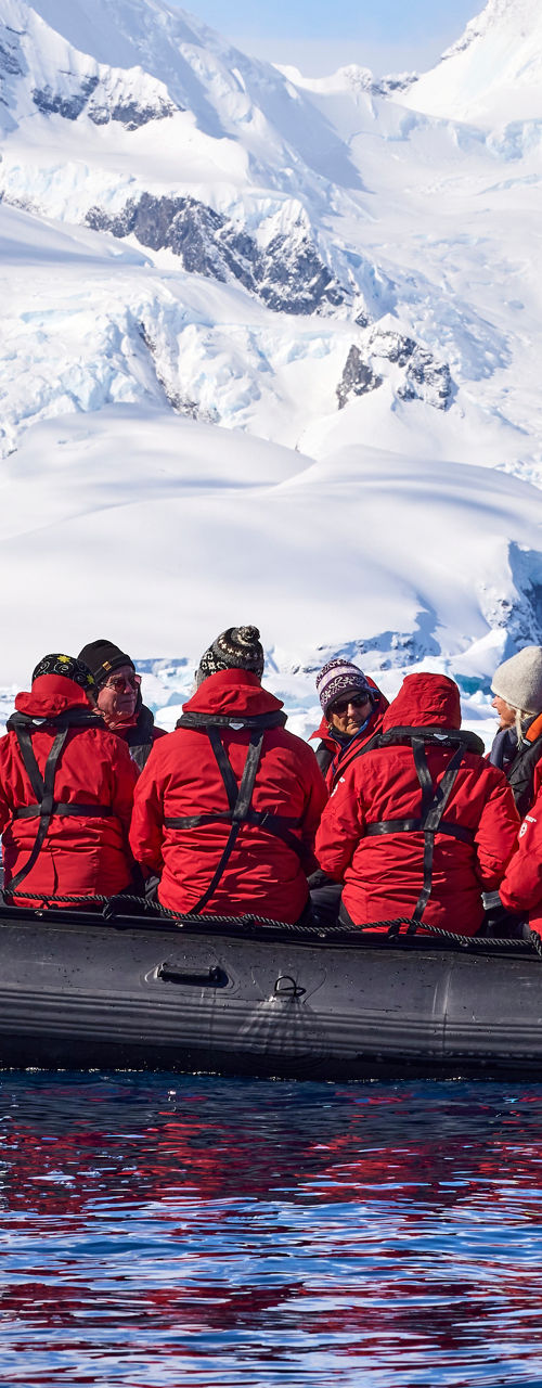 Group in red jackets on Arctic expedition boat