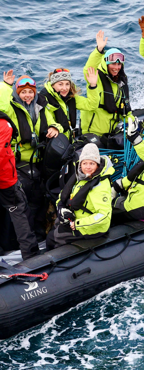 Group on inflatable boat in ocean waters