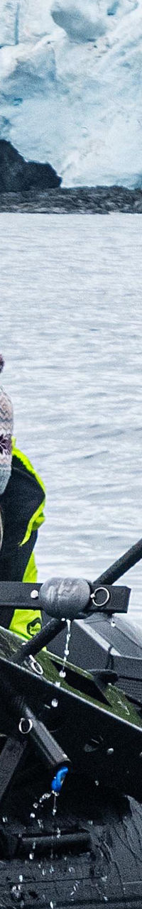 Researchers on inflatable boat in icy waters