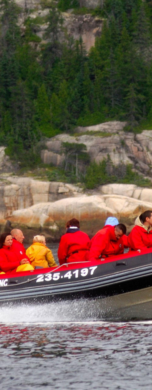 Tourists on speedboat in scenic waters