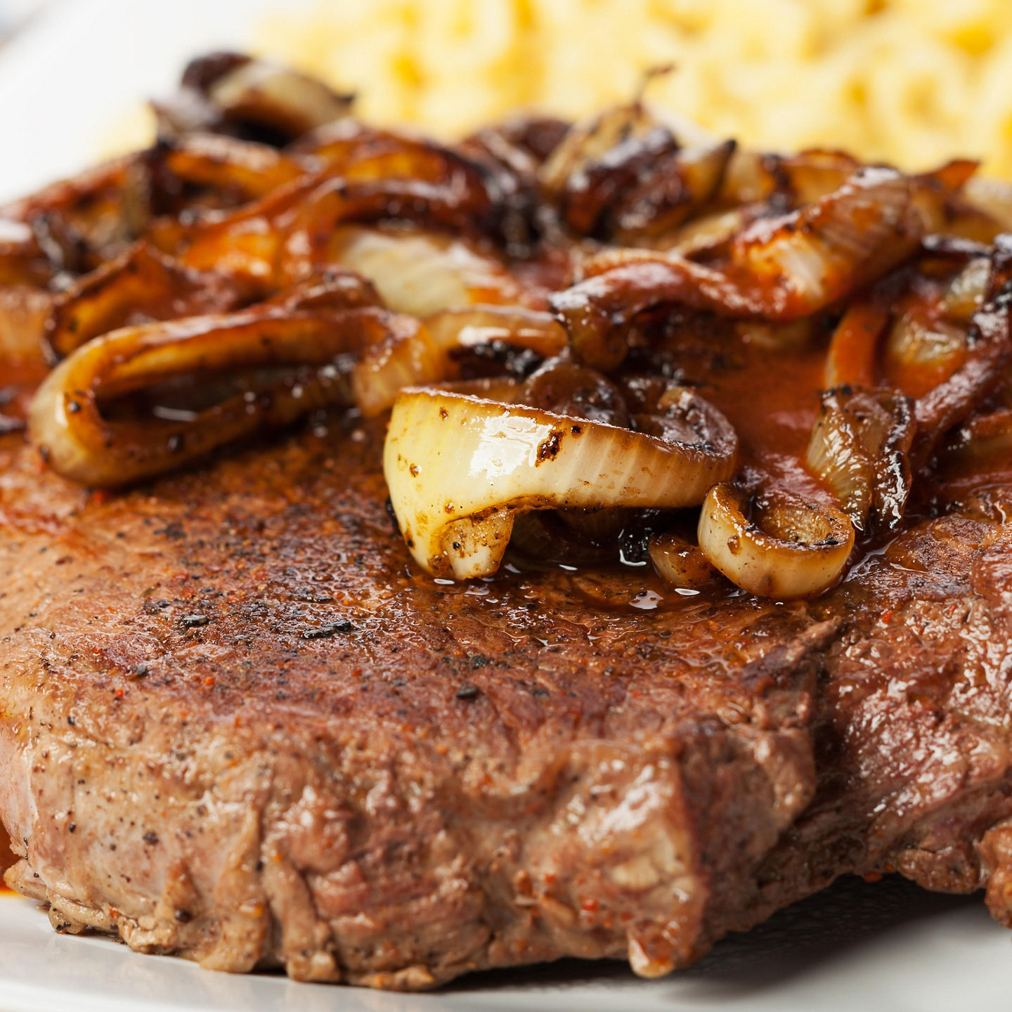 Grilled steak with caramelized onions